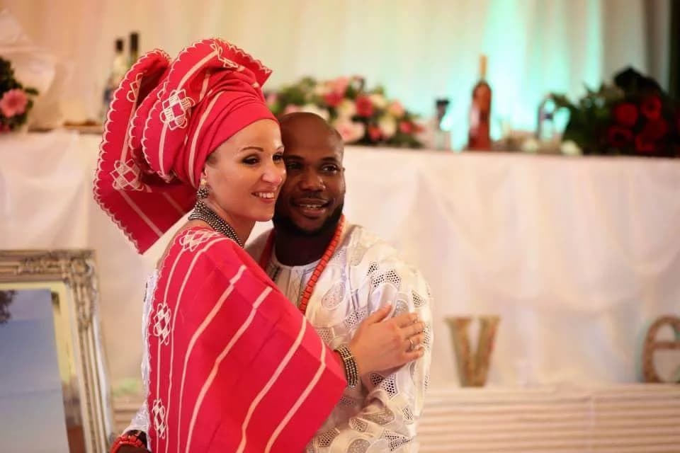 Couple celebrating in traditional dress at a reception