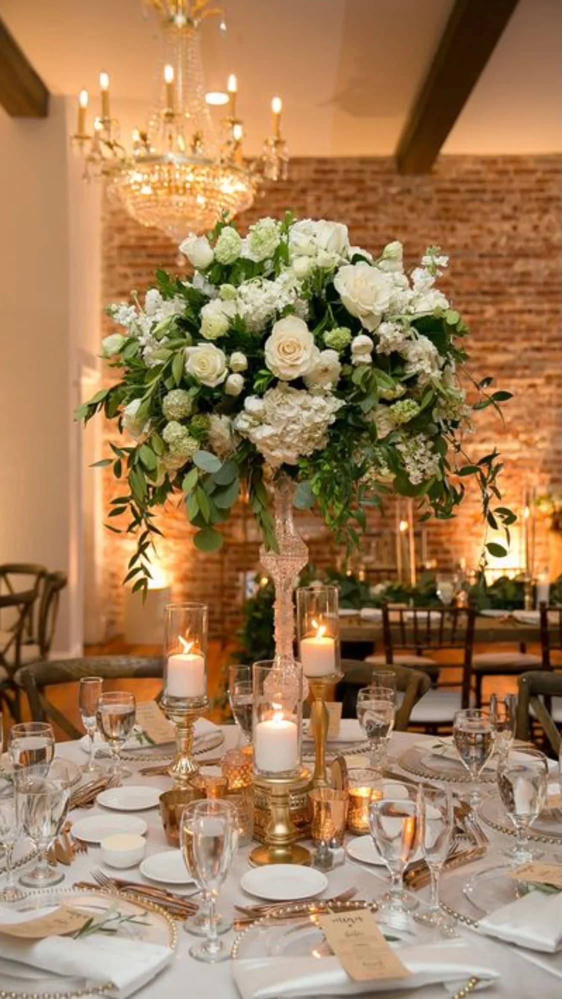 Reception table styled with white florals and candlelight